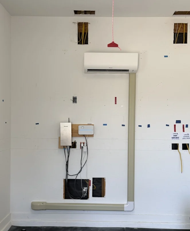 Wall-mounted mini-split and covered line routing during installation